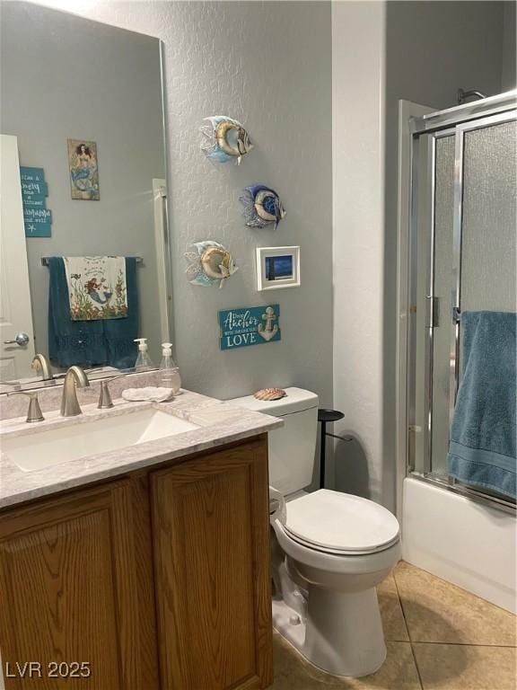 2345 Minolta Ct, Henderson, NV 89044 - full bathroom with vanity, tile patterned flooring, enclosed tub / shower combo, and a textured wall