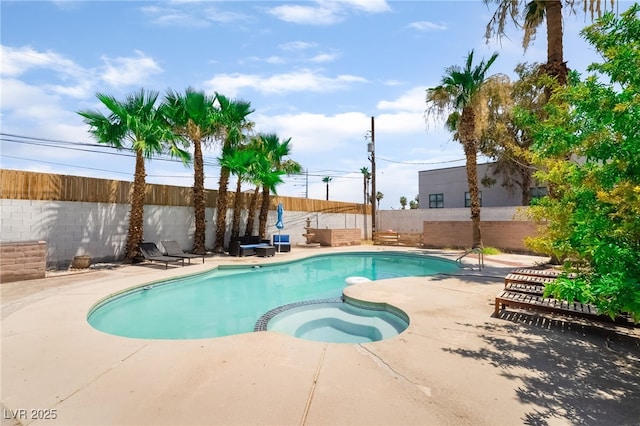 5676 Birchwood Cir, Las Vegas, NV 89120 - view of swimming pool with a pool with connected hot tub, a patio area, and a fenced backyard