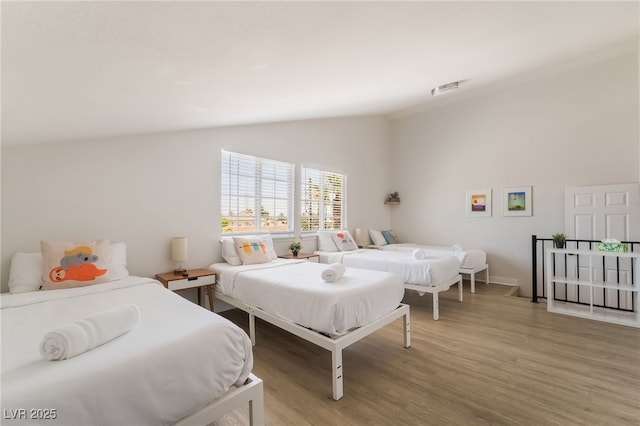 5676 Birchwood Cir, Las Vegas, NV 89120 - bedroom featuring vaulted ceiling and wood finished floors