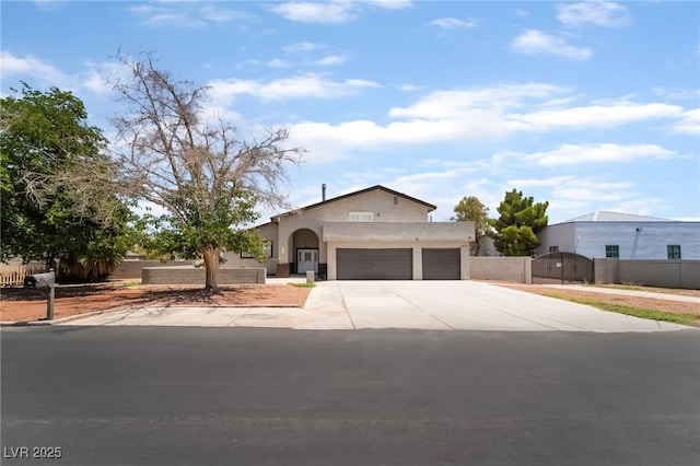 5676 Birchwood Cir, Las Vegas, NV 89120 - view of front of property featuring a garage, a gate, stucco siding, and driveway