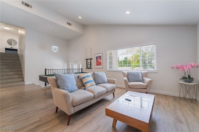 5676 Birchwood Cir, Las Vegas, NV 89120 - living area with light wood-style flooring, vaulted ceiling, and recessed lighting