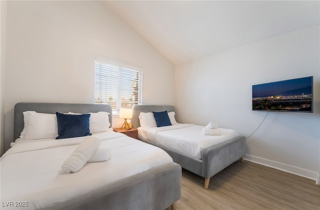 5676 Birchwood Cir, Las Vegas, NV 89120 - bedroom featuring light wood finished floors and vaulted ceiling
