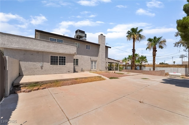 5676 Birchwood Cir, Las Vegas, NV 89120 - back of house featuring a patio area, stucco siding, and a chimney