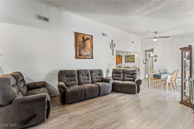 108 Sirnoble St, Las Vegas, NV 89110 - living room featuring light wood-type flooring, a textured ceiling, and ceiling fan