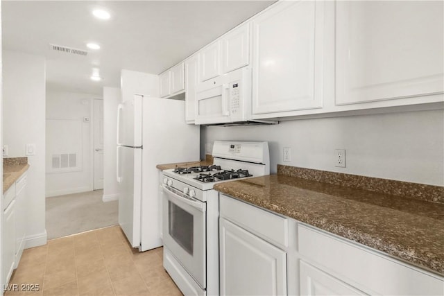 2801 N Rainbow Blvd Unit 235, Las Vegas, NV 89108 - kitchen with white appliances, white cabinetry, dark stone counters, recessed lighting, and light tile patterned flooring