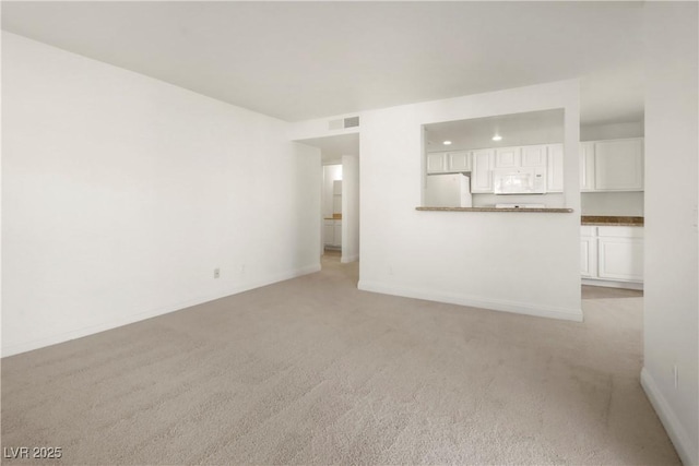 2801 N Rainbow Blvd Unit 235, Las Vegas, NV 89108 - unfurnished living room with light carpet and baseboards