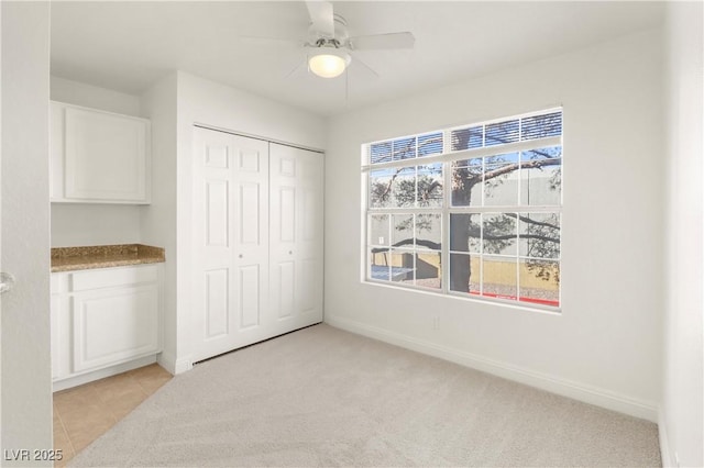 2801 N Rainbow Blvd Unit 235, Las Vegas, NV 89108 - unfurnished bedroom featuring a closet, ceiling fan, and light carpet