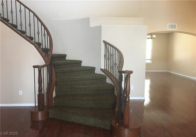 7414 Page Ranch Ct, Las Vegas, NV 89131 - stairs with wood finished floors, arched walkways, and a chandelier