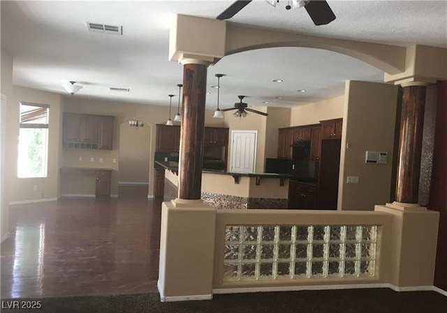 7414 Page Ranch Ct, Las Vegas, NV 89131 - kitchen featuring decorative columns, ceiling fan, a kitchen island, dark brown cabinetry, and recessed lighting
