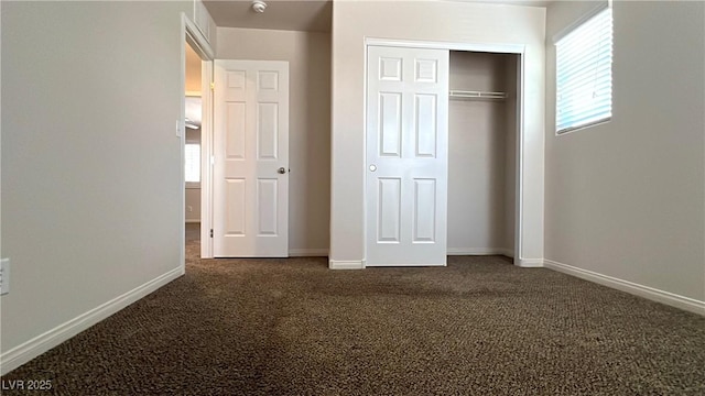 7469 Paces Mill Ct, Las Vegas, NV 89113 - unfurnished bedroom with dark carpet, multiple windows, and a closet
