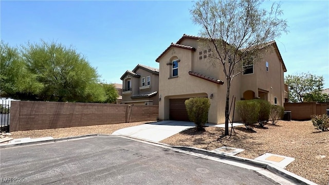 7469 Paces Mill Ct, Las Vegas, NV 89113 - view of home's exterior with an attached garage, driveway, stucco siding, and a tile roof