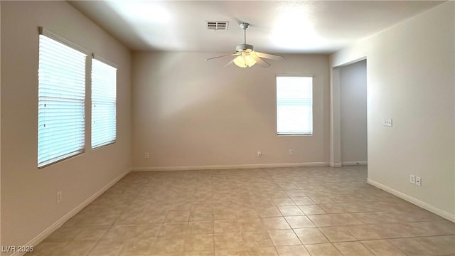 7469 Paces Mill Ct, Las Vegas, NV 89113 - empty room with healthy amount of natural light, a ceiling fan, and light tile patterned floors