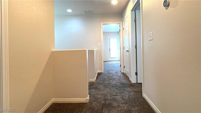 7469 Paces Mill Ct, Las Vegas, NV 89113 - hallway with dark colored carpet, an upstairs landing, and recessed lighting