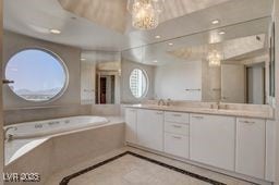 2877 Paradise Rd Unit 904, Las Vegas, NV 89109 - full bathroom with a chandelier, double vanity, a garden tub, and inlaid floor details