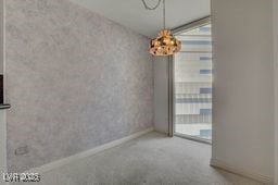 2877 Paradise Rd Unit 904, Las Vegas, NV 89109 - unfurnished dining area with carpet flooring and baseboards