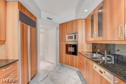 2877 Paradise Rd Unit 904, Las Vegas, NV 89109 - kitchen featuring dishwasher, oven, and glass insert cabinets