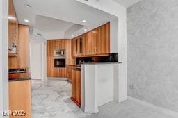2877 Paradise Rd Unit 904, Las Vegas, NV 89109 - kitchen featuring brown cabinets, dark countertops, and recessed lighting