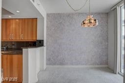 2877 Paradise Rd Unit 904, Las Vegas, NV 89109 - kitchen with brown cabinets and dark countertops