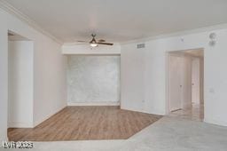 2877 Paradise Rd Unit 904, Las Vegas, NV 89109 - empty room featuring ornamental molding, a ceiling fan, and wood finished floors