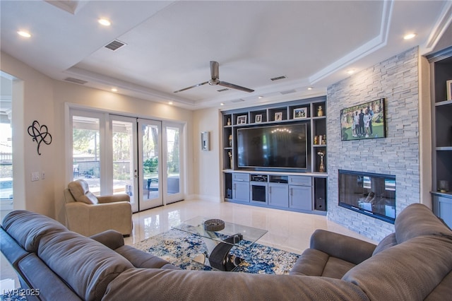 1890 Pago Ct, Las Vegas, NV 89117 - living room with french doors, a raised ceiling, ceiling fan, built in shelves, and a fireplace