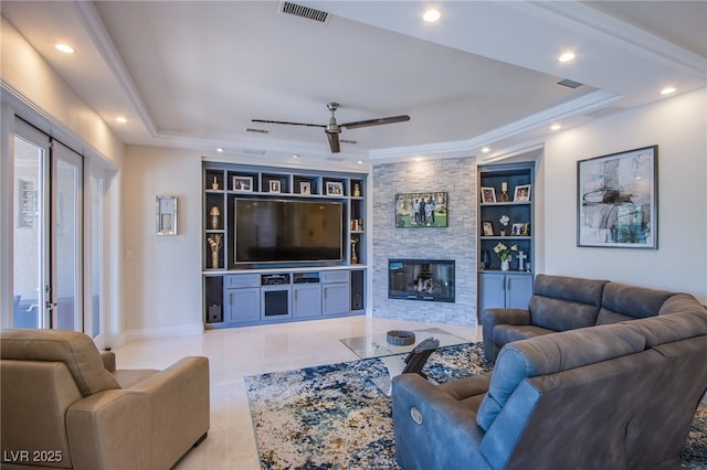 1890 Pago Ct, Las Vegas, NV 89117 - living area featuring a raised ceiling, ceiling fan, built in shelves, a stone fireplace, and recessed lighting