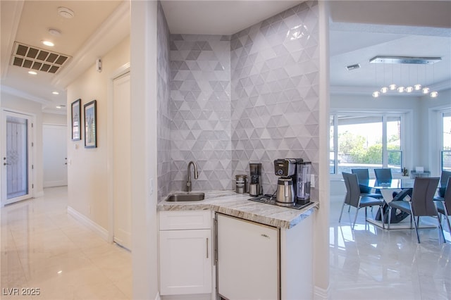 1890 Pago Ct, Las Vegas, NV 89117 - kitchen featuring white cabinets, tasteful backsplash, light stone countertops, ornamental molding, and recessed lighting
