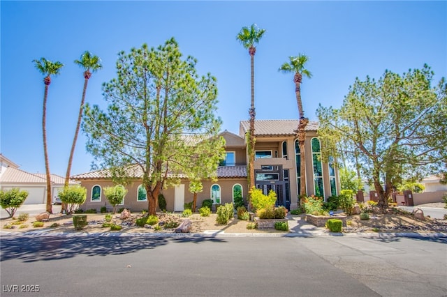 1890 Pago Ct, Las Vegas, NV 89117 - mediterranean / spanish house featuring a tile roof and stucco siding