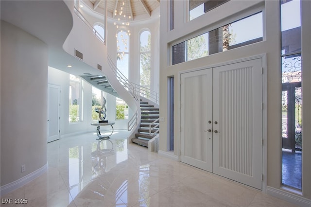 1890 Pago Ct, Las Vegas, NV 89117 - foyer entrance featuring a high ceiling, stairway, marble tiled flooring, and french doors