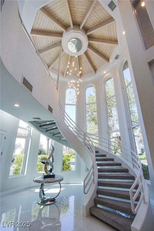 1890 Pago Ct, Las Vegas, NV 89117 - stairway with a high ceiling, healthy amount of natural light, and a wood ceiling with exposed beams