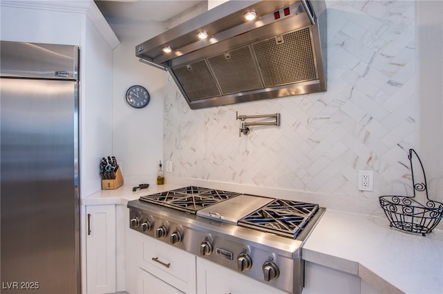 1890 Pago Ct, Las Vegas, NV 89117 - kitchen with ventilation hood, stainless steel appliances, light countertops, and tasteful backsplash