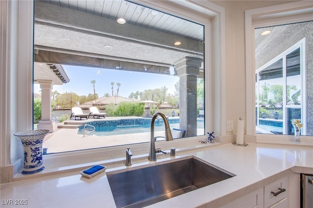 1890 Pago Ct, Las Vegas, NV 89117 - kitchen with white cabinets, light countertops, and decorative columns