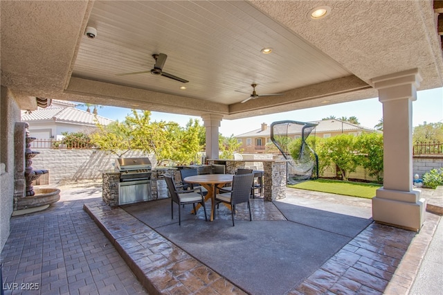 1890 Pago Ct, Las Vegas, NV 89117 - fenced backyard with an outdoor kitchen, outdoor dining space, a patio area, and a ceiling fan
