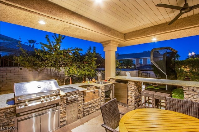 1890 Pago Ct, Las Vegas, NV 89117 - fenced backyard with area for grilling, outdoor dining area, a patio area, and a ceiling fan