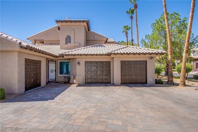 1890 Pago Ct, Las Vegas, NV 89117 - mediterranean / spanish-style house with stucco siding, a tile roof, an attached garage, and decorative driveway