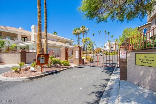 1890 Pago Ct, Las Vegas, NV 89117 - view of asphalt street featuring a gate, curbs, a gated entry, and a residential view