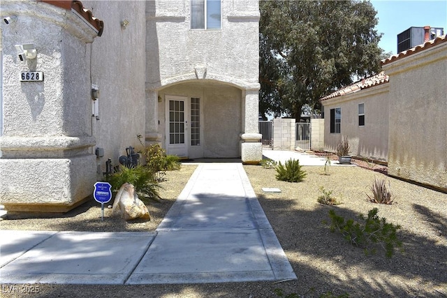 6628 Ives Ave, Las Vegas, NV 89108 - view of exterior entry with stucco siding and a gate