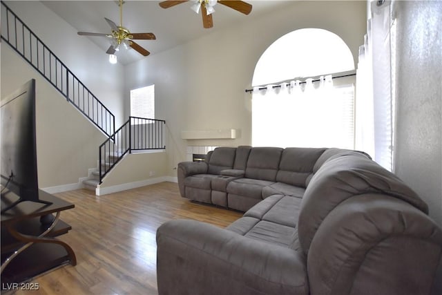 6628 Ives Ave, Las Vegas, NV 89108 - living area with a ceiling fan, wood finished floors, stairs, and vaulted ceiling