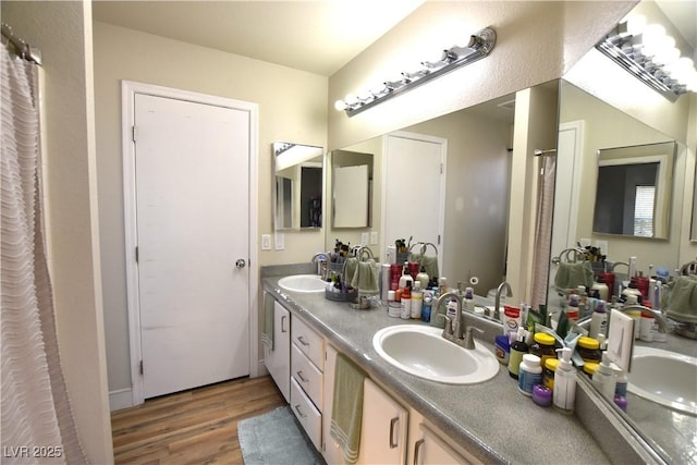 6628 Ives Ave, Las Vegas, NV 89108 - bathroom featuring wood finished floors and double vanity