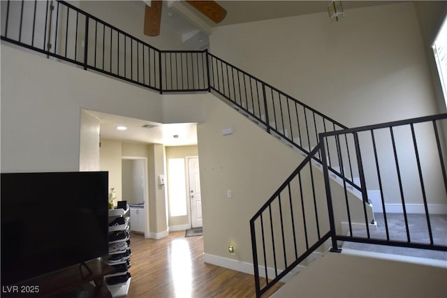 6628 Ives Ave, Las Vegas, NV 89108 - staircase with a towering ceiling, ceiling fan, and wood finished floors