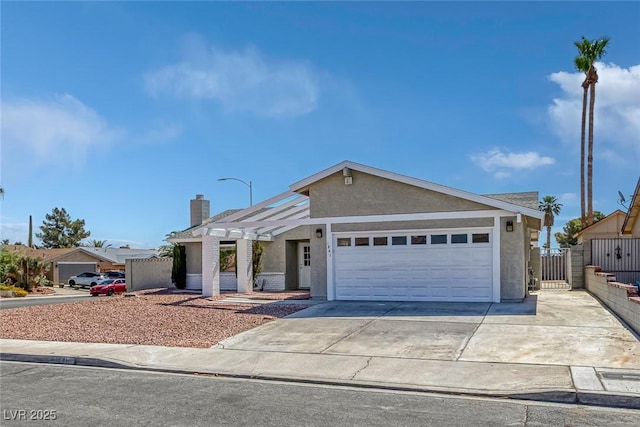 1841 Feather Way, Las Vegas, NV 89108 - view of front facade featuring stucco siding, concrete driveway, a garage, and a chimney