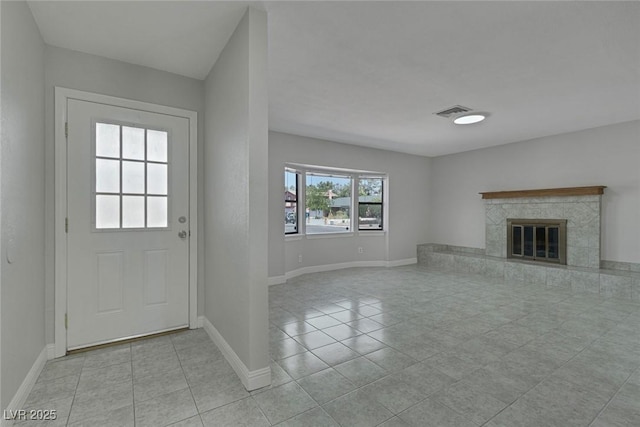 1841 Feather Way, Las Vegas, NV 89108 - unfurnished living room featuring light tile patterned floors and a tiled fireplace