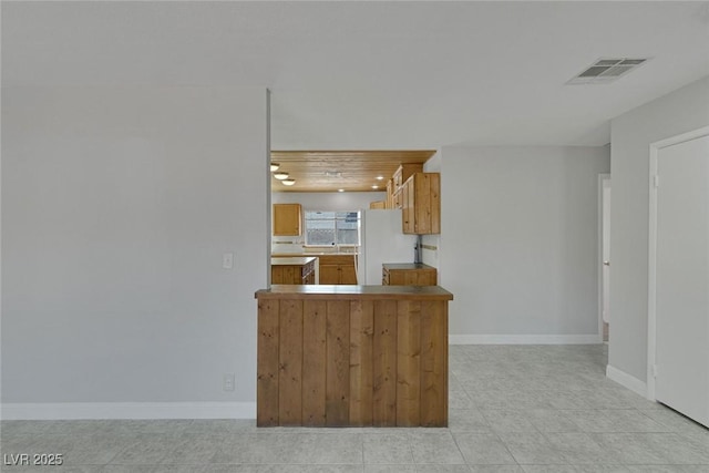 1841 Feather Way, Las Vegas, NV 89108 - kitchen featuring freestanding refrigerator, light tile patterned floors, and brown cabinetry