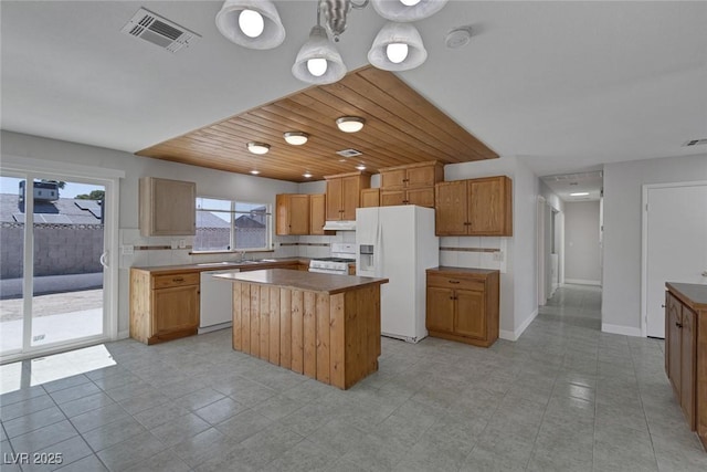 1841 Feather Way, Las Vegas, NV 89108 - kitchen with white appliances, under cabinet range hood, a kitchen island, wood ceiling, and backsplash