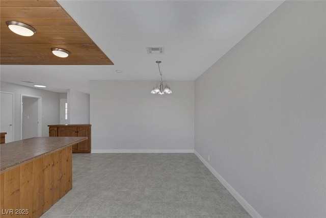 1841 Feather Way, Las Vegas, NV 89108 - unfurnished dining area featuring baseboards and a chandelier
