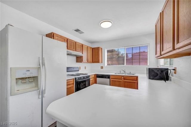2165 Saint Paul Way, Las Vegas, NV 89104 - kitchen featuring white appliances, under cabinet range hood, a peninsula, and plenty of natural light