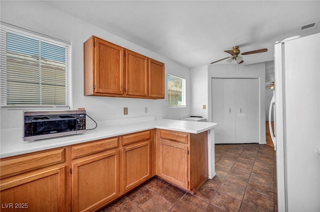 2165 Saint Paul Way, Las Vegas, NV 89104 - kitchen featuring freestanding refrigerator, a peninsula, a ceiling fan, light countertops, and brown cabinetry