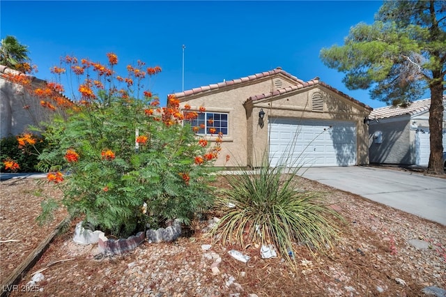 2165 Saint Paul Way, Las Vegas, NV 89104 - view of front facade with stucco siding, driveway, a garage, and a tile roof