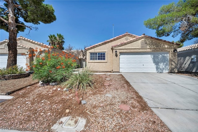 2165 Saint Paul Way, Las Vegas, NV 89104 - ranch-style house with stucco siding, driveway, a tiled roof, and an attached garage