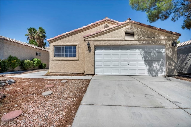 2165 Saint Paul Way, Las Vegas, NV 89104 - mediterranean / spanish home with stucco siding, a tile roof, driveway, and a garage