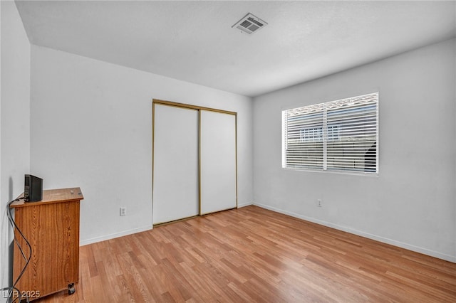 2165 Saint Paul Way, Las Vegas, NV 89104 - unfurnished bedroom with light wood-style floors and a closet